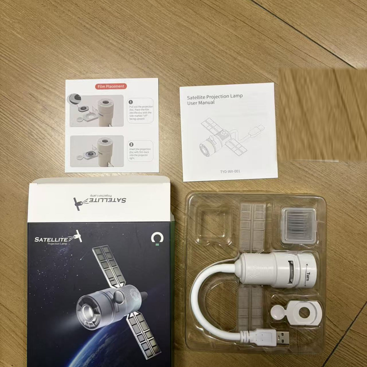 Standard unboxing — projector, discs tray, and accessories
